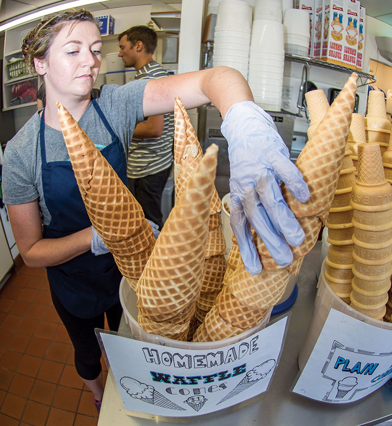Big Dipper employee Rose Newman grabs one of the shop’s homemade waffle cones.