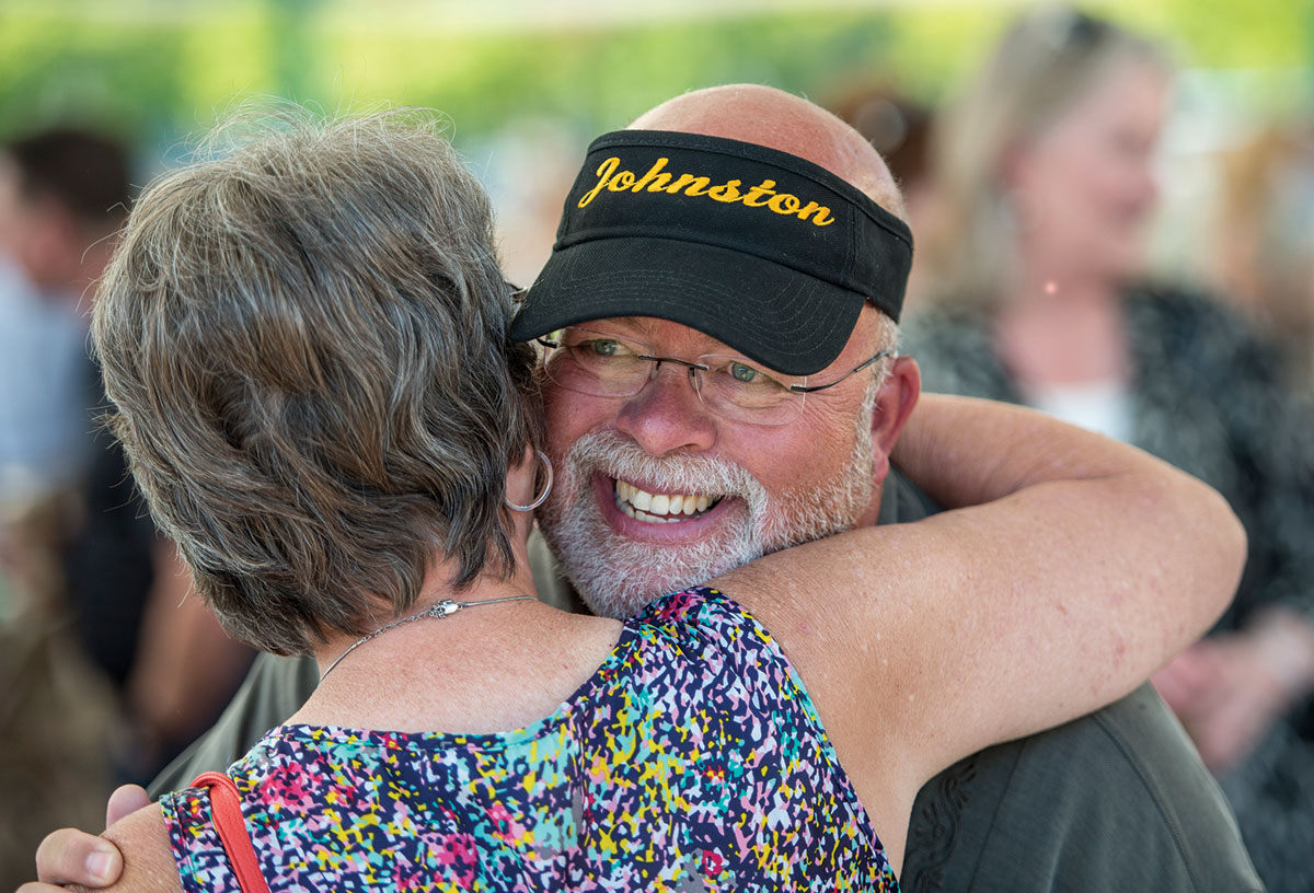 Bill Johnston gets a hug from a well-wisher at his retirement party in August, which was held at Caras Park in Missoula. More than 300 people were in attendance.