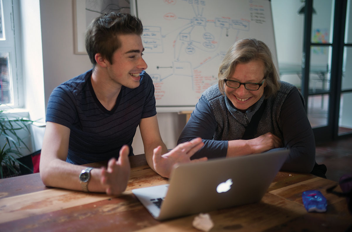 UM student Greg Arno shows UM Associate Professor Henriette Löwisch his nearly completed project in the final hours before deadline. Arno branched off a bit to create a storytelling app for refugees, allowing them to share their own experiences on an online platform.