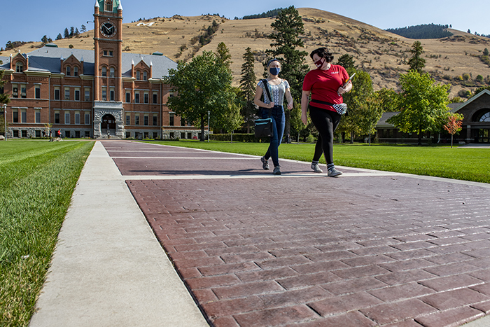 Two UM students walk on the newly paved Oval walkways.