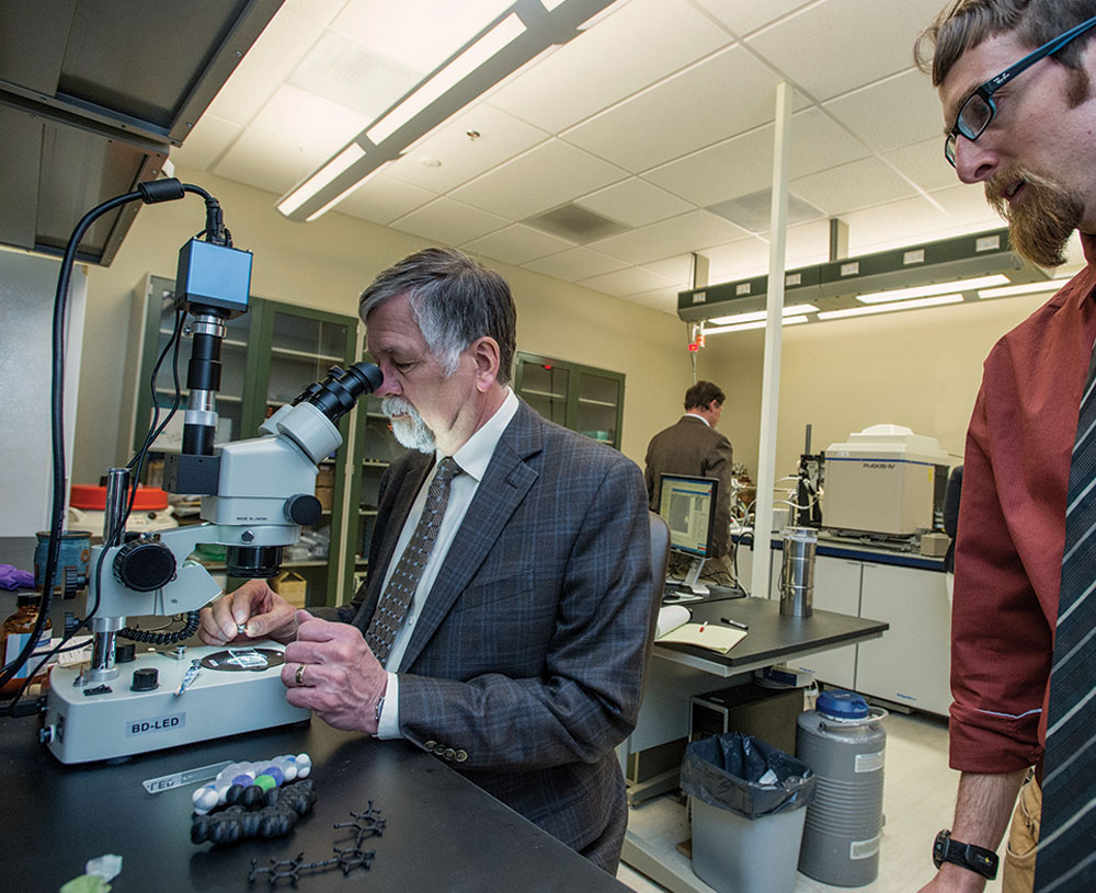 President Royce Engstrom prepares a crystal sample for the state-of-the-art X-ray diffractometer inside the lab of Assistant Professor Orion Berryman.