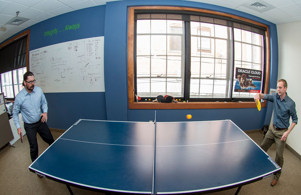 Chad Nixon '07 and Cory Bartholomew play ping-pong during a break from their jobs at ATG.