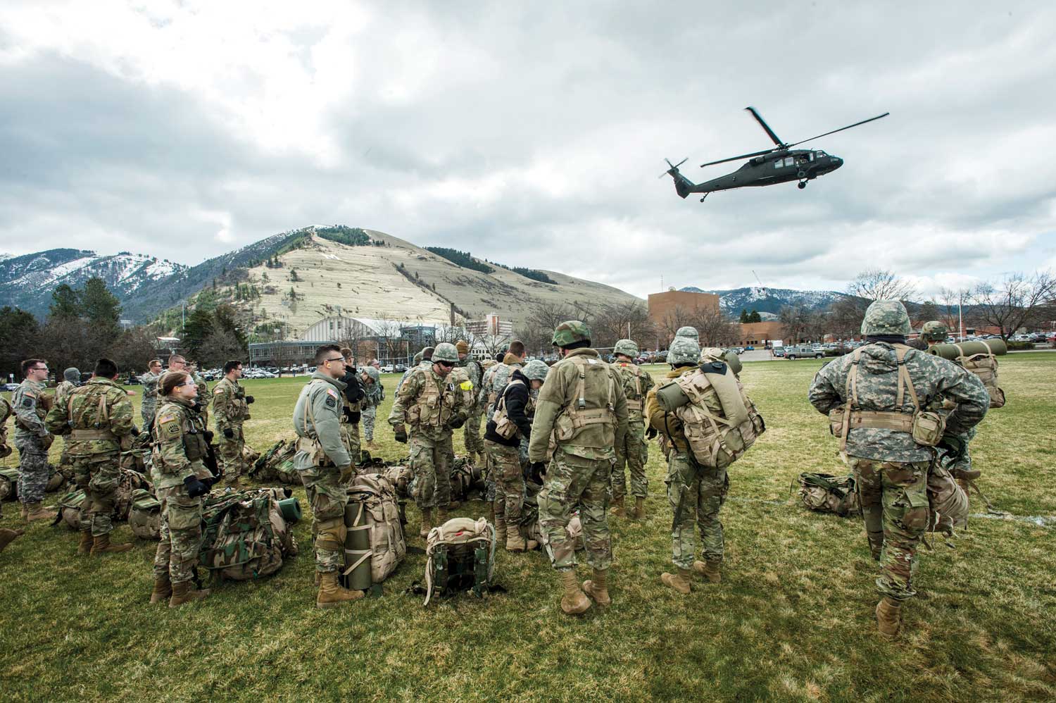 Grizzly Battalion cadets watch a Montana National Guard Blackhawk helicopter take off from campus during April training exercises.