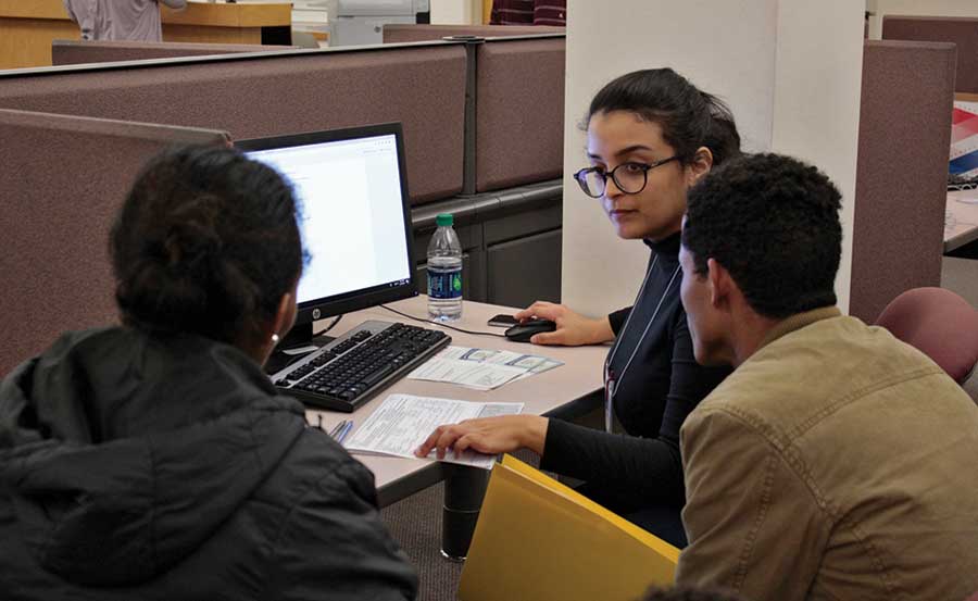 UM Master of Accountancy student Sahar Qasem Muthna helps a refugee family file taxes.