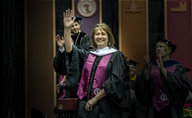 Denise Juneau waves to the crowd at UM Commencement