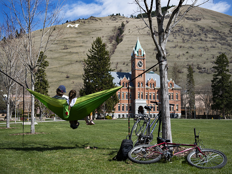UM students sitting on the oval in a hammock