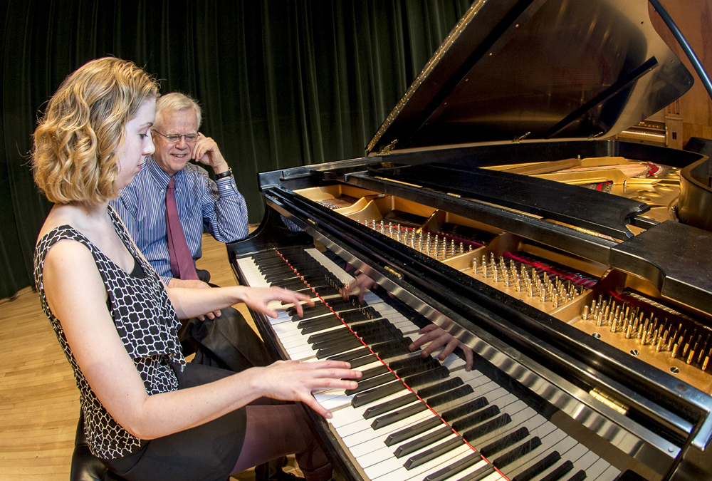 UM music Professor Steven Hesla works with Megan Meadows, a piano pedagogy major, on UM’s concert grand piano.