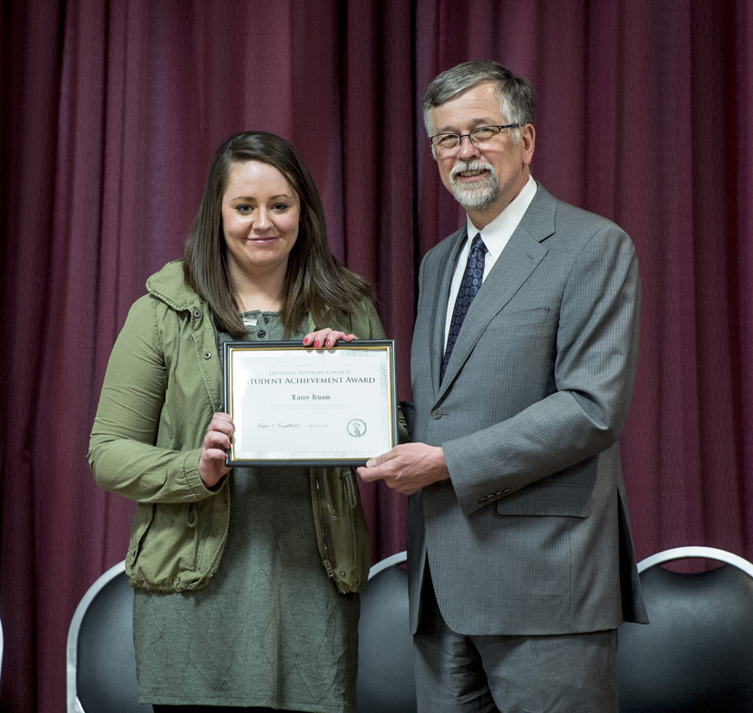 UM student Lacey Kvam of Polson receives her award from President Royce Engstrom.