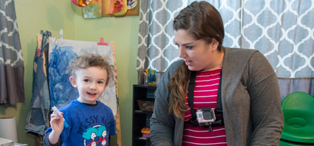 Raelynn Cameron, a master’s student in early education, wears a GoPro camera while she works with Henry Hamilton, age 4, at her in-home family child care center in East Missoula.