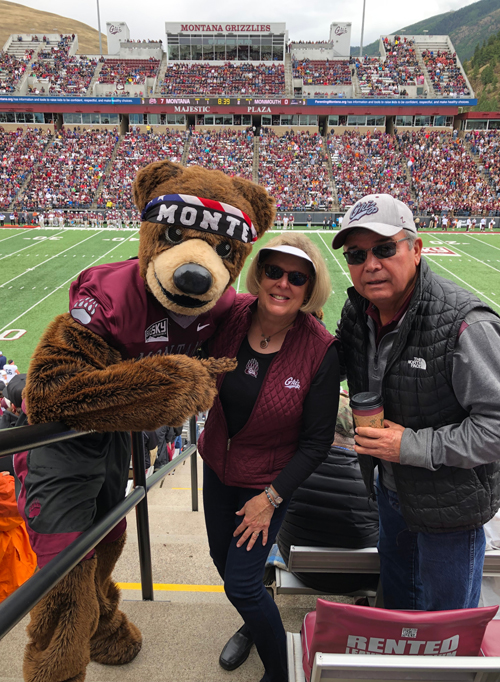 Monte visits Debby Beals and Keith Beartusk during a Griz football game