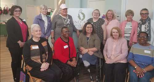 Sen. Tammy Duckworth, lead sponsor for the Senate’s Breast Cancer Patient Equity Act, visited the boutique to meet with breast cancer survivors. Sheehan is pictured in back row, third from right.