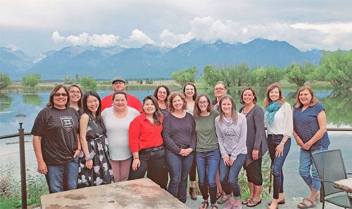 Dr. Jingjing Sun, third from left, and her team pose for a photo with mountains in the background