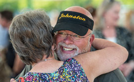 Bill Johnston gets a hug from a well-wisher at his retirement party in August, which was held at Caras Park in Missoula. More than 300 people were in attendance.