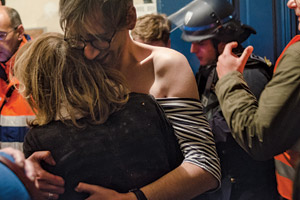 Two audience members reunite after being separated during the shooting at the Bataclan concert hall.