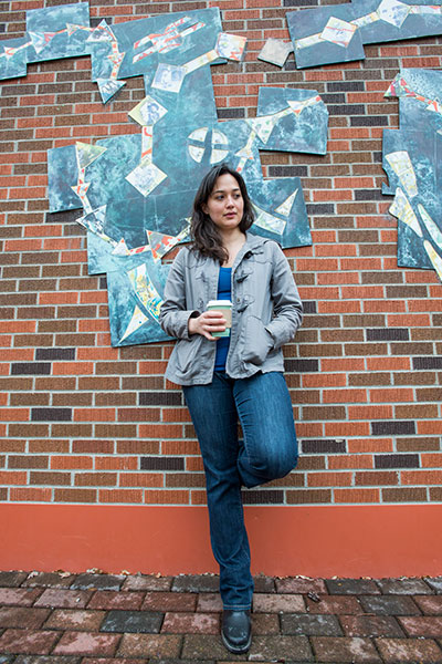 Lily Gladstone drinks coffee near Urey Lecture Hall on UM's campus.