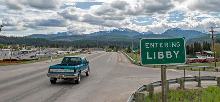 A sign welcomes visitors to Libby on a bridge crossing the Kootenai River. Residents of Libby are ready to move on from its tarnished past and focus on the future.