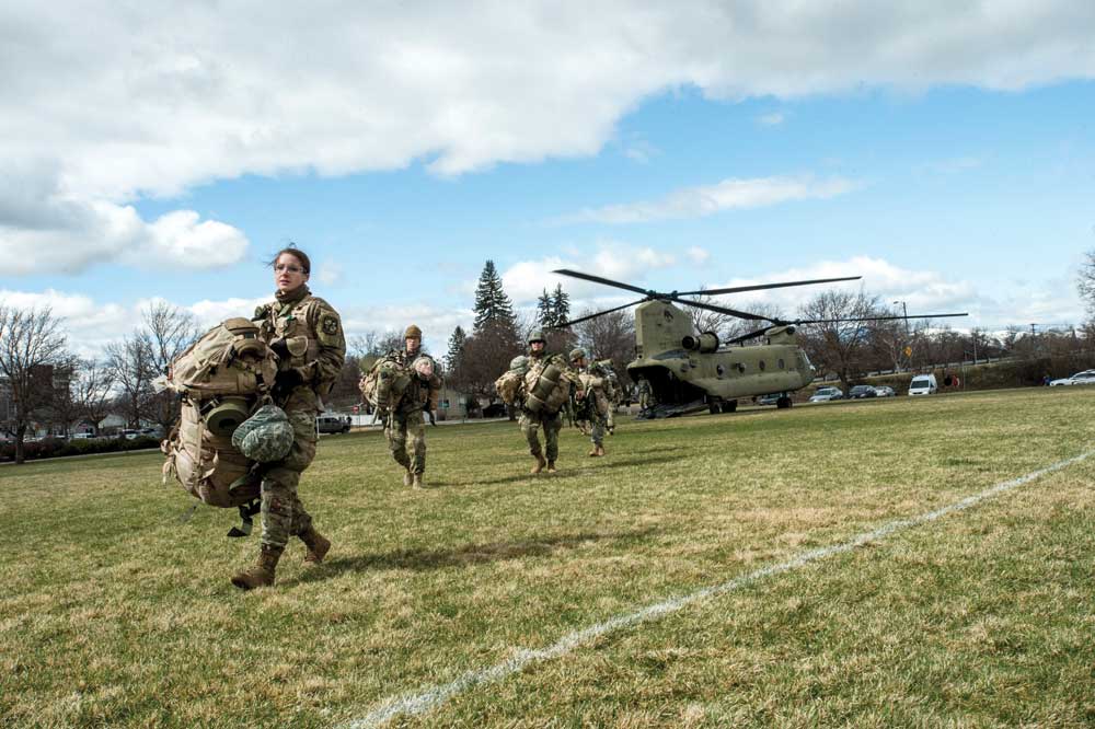 Ashley White, a junior in ROTC, leads a group of cadets exiting a Montana National Guard Chinook helicopter during spring  training exercises.