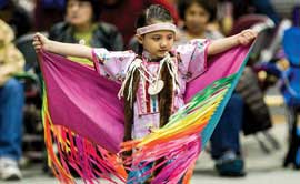 Five-year-old Cianna Belle DesRosier of Browning (Maatsui Suipoyaukii “Loon Woman” in Blackfeet) enjoys UM’s 50th annual Kyiyo Celebration. 