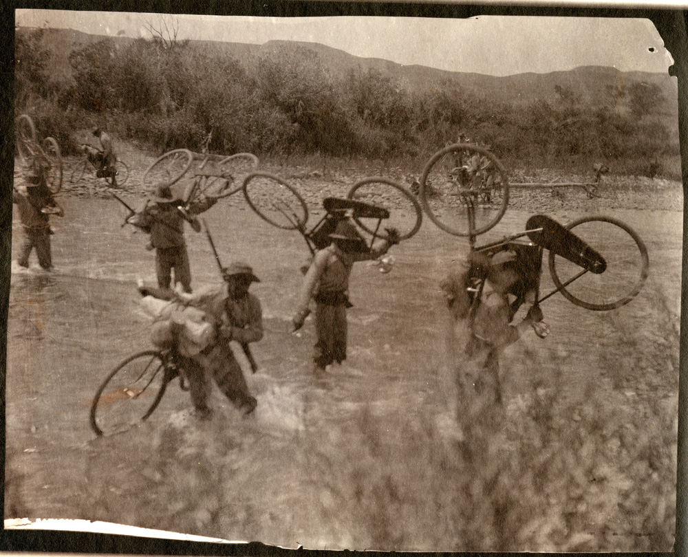 Members of the 25th Infantry Bicycle Corps cross a creek. (Photo: umt013386, Archives & Special Collections, Mansfield Library, the University of Montana)