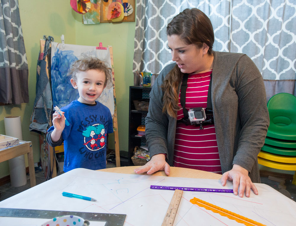 Raelynn Cameron, a master’s student in early education, wears a GoPro camera while she works with Henry Hamilton, age 4, at her in-home family child care center in East Missoula.